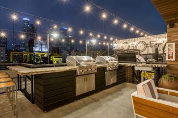 an outdoor kitchen with a city skyline in the background